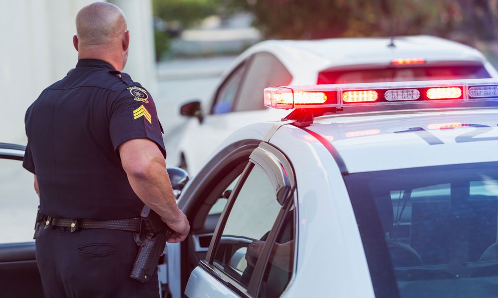 Police Officer Getting Out Of Cruiser