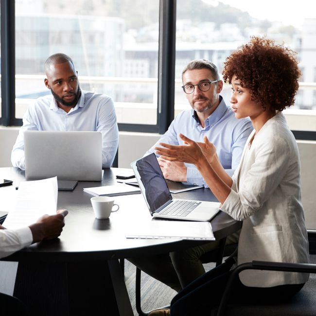 Millennial Black Businesswoman Addressing Colleagues At A Corporate Business Meeting, Close Up