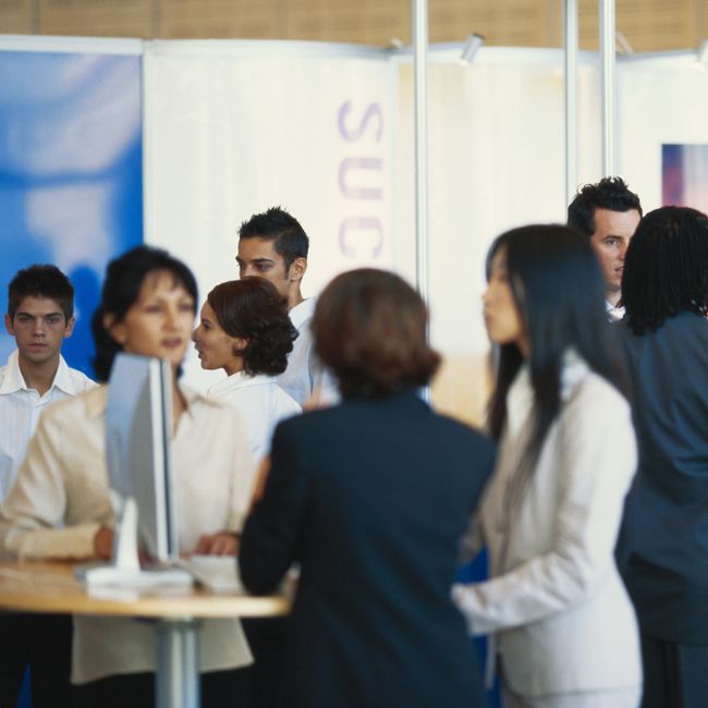 Business Executives Standing In Exhibition Hall